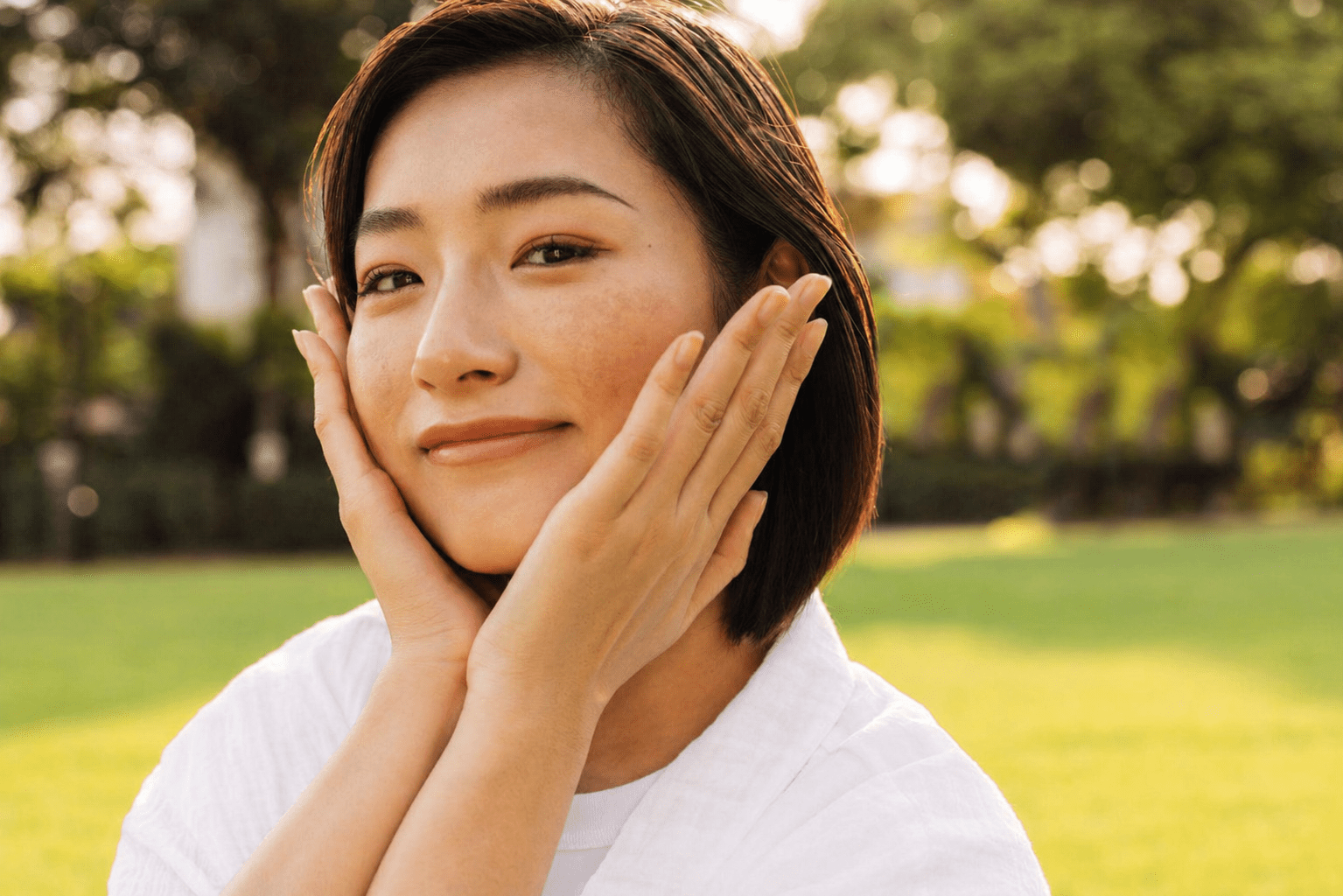 woman with melasma on cheeks showing natural skin with soft hyperpigmentation in sunlight